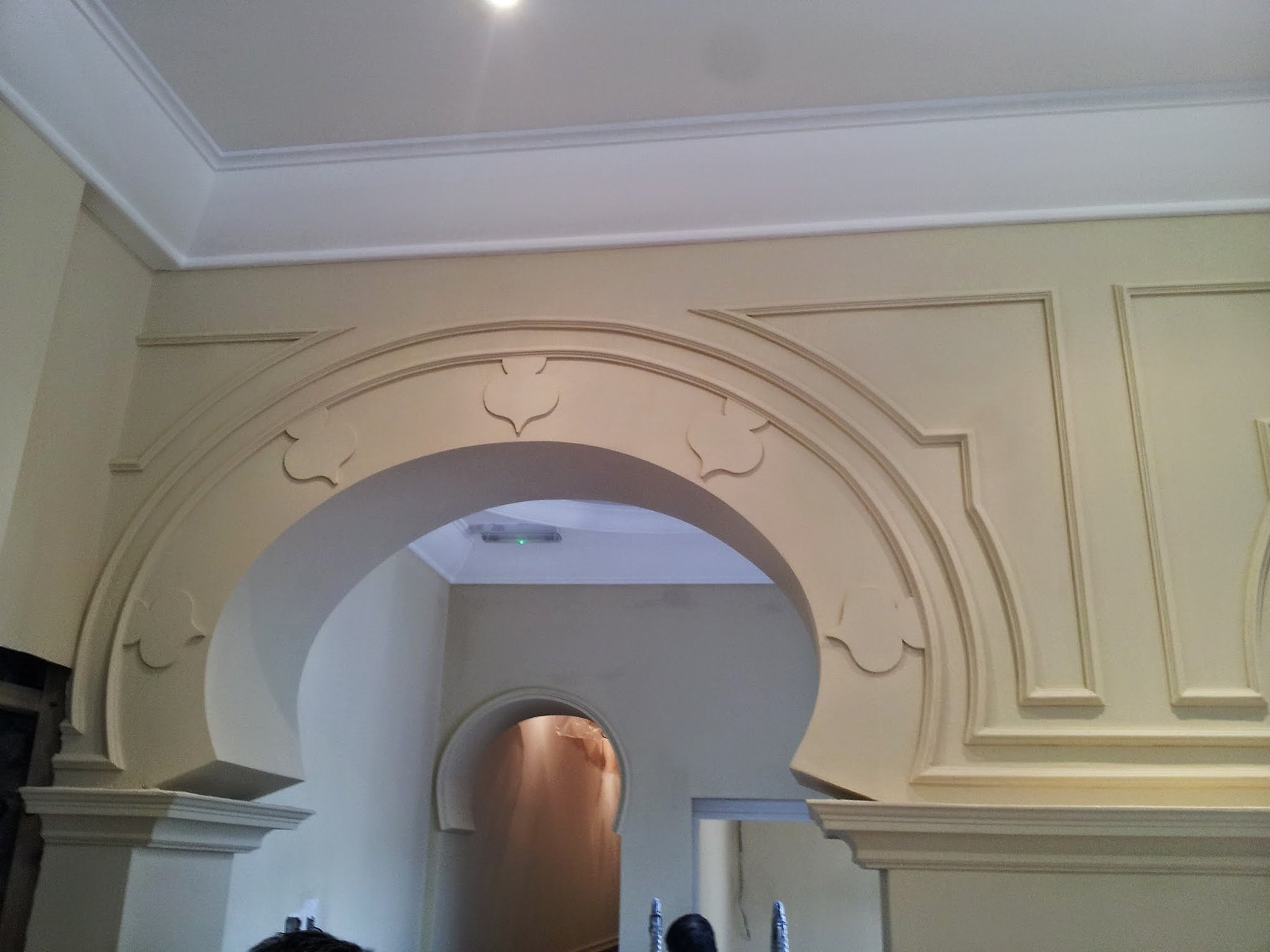 The moulded arch from the side, with panel mouldings on the wall around it