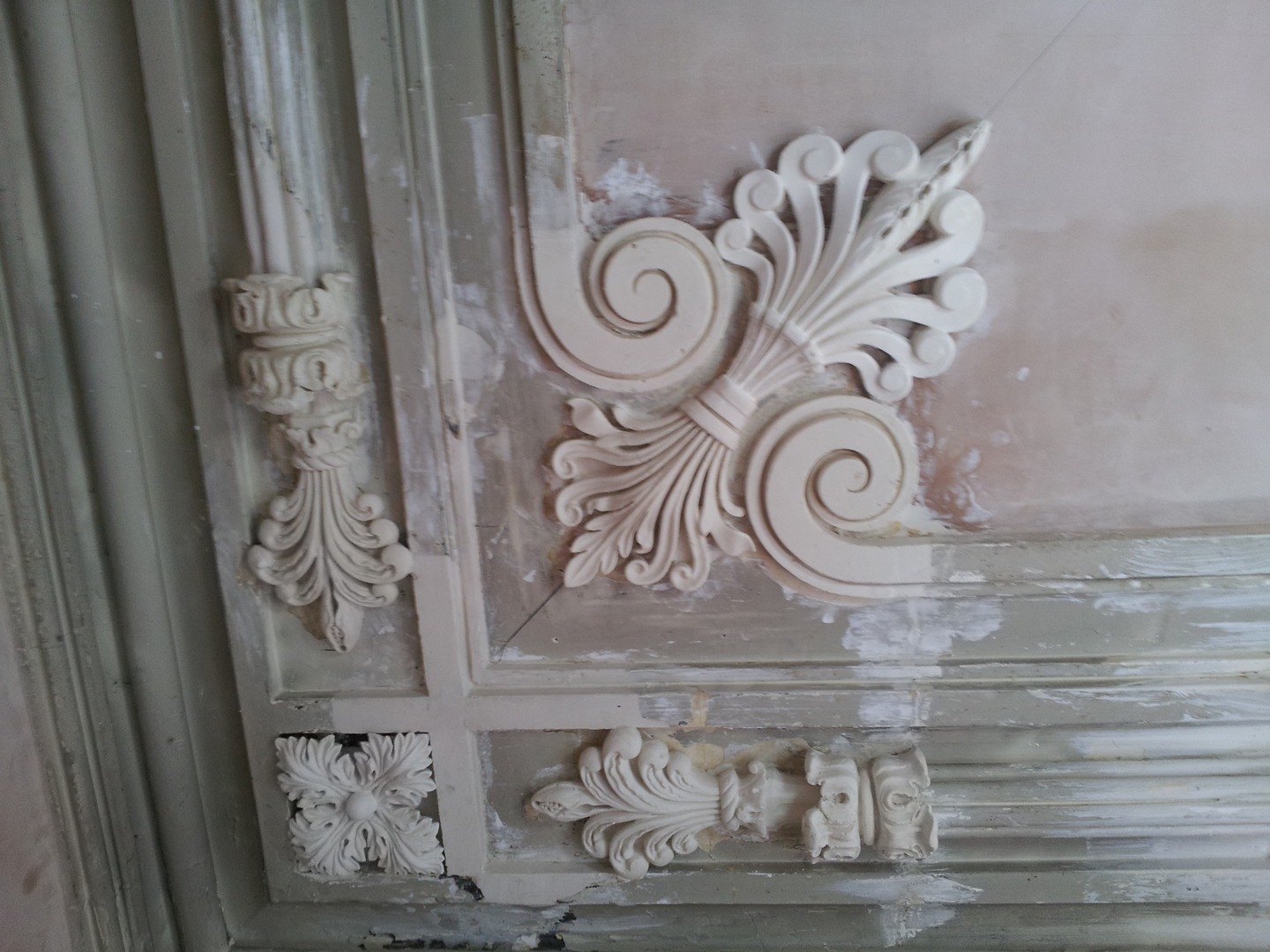 New plaster enrichments set into an old decorated ceiling during restoration