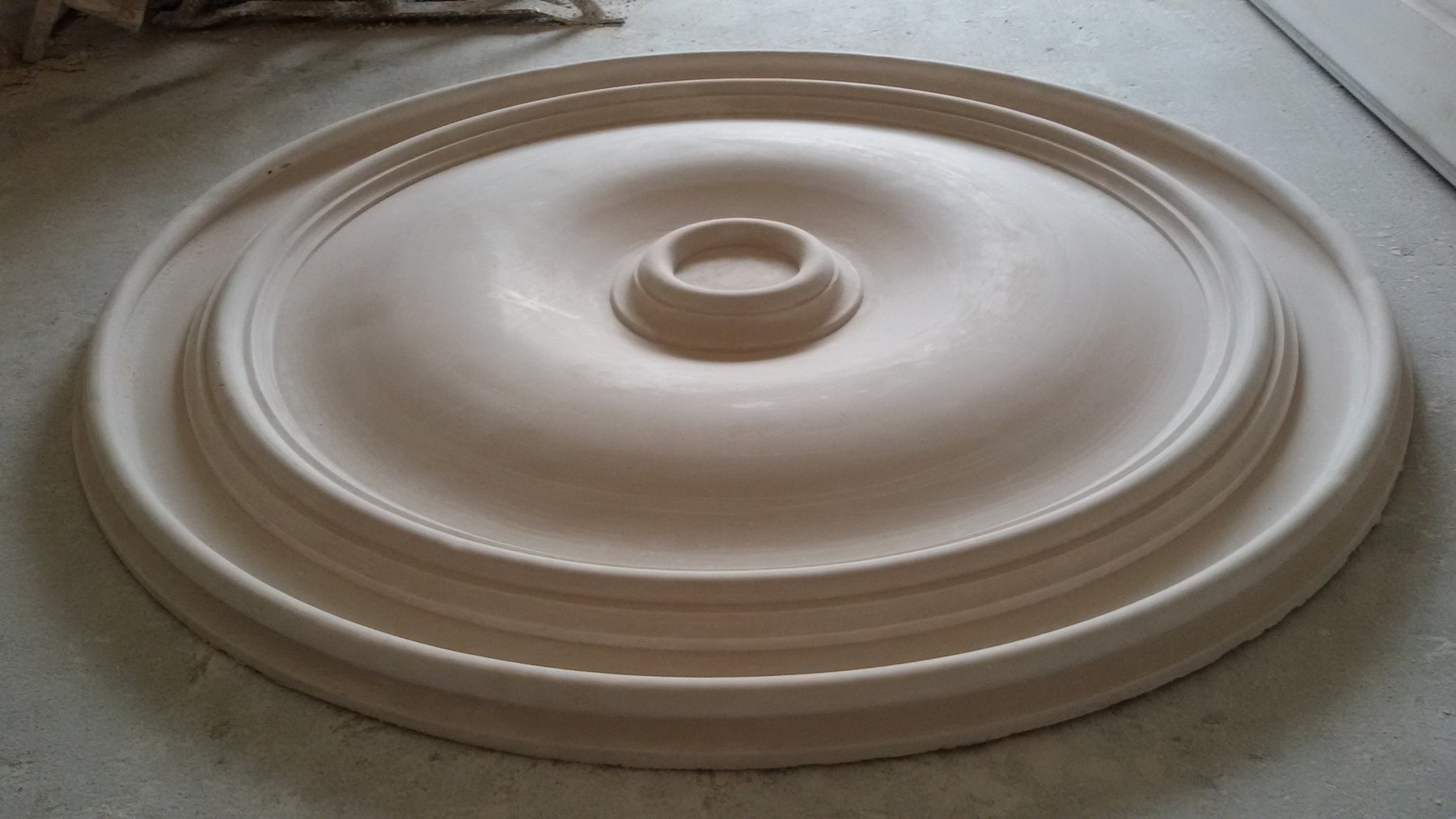 A large plain ceiling centre, one metre across, on the workshop floor