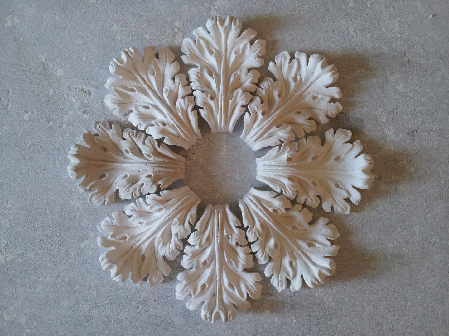 A small ceiling rose of acanthus leaves on the workshop floor